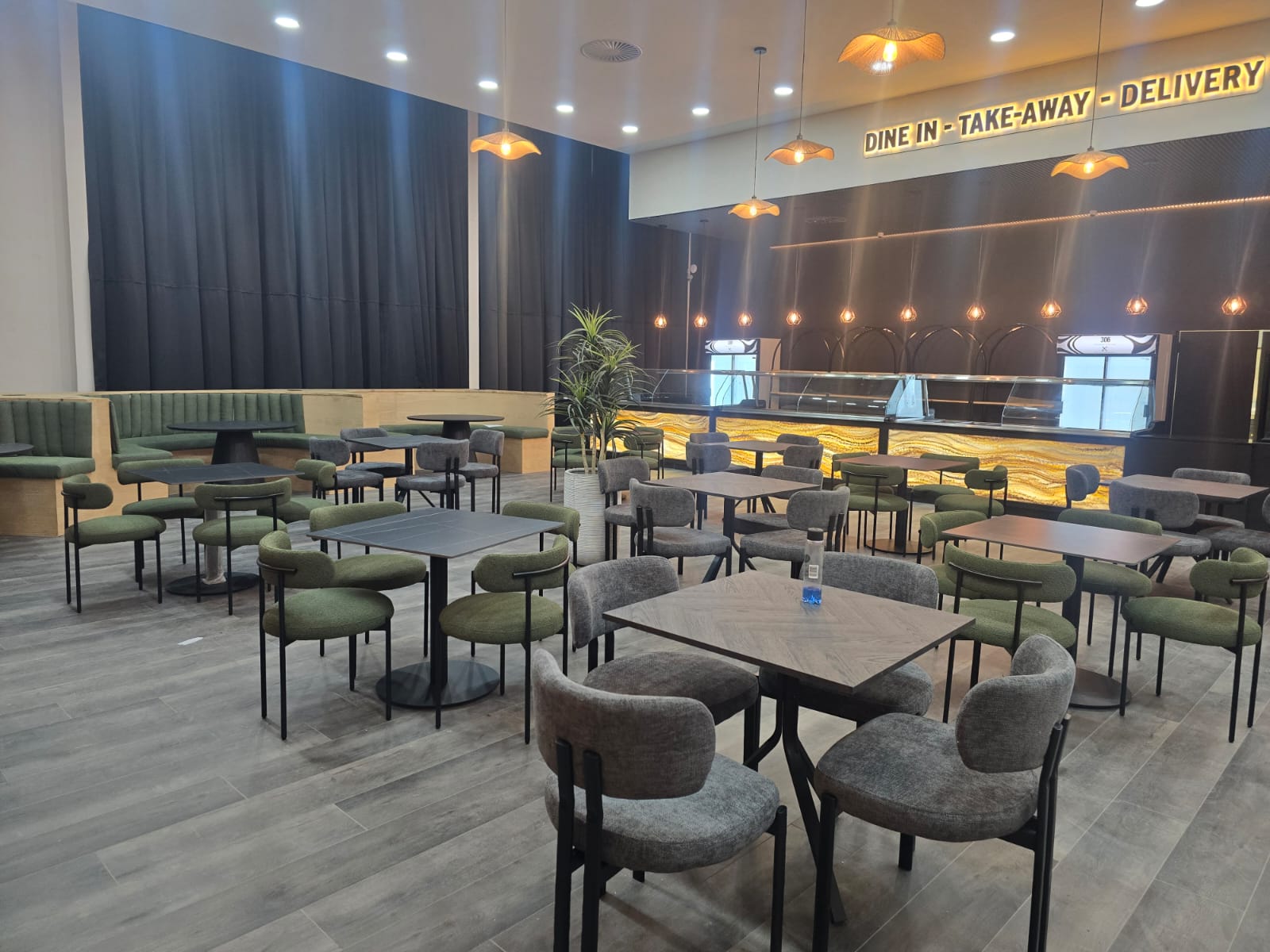 Restaurant dining area with suspended ceiling, bulkhead and feature counter lighting