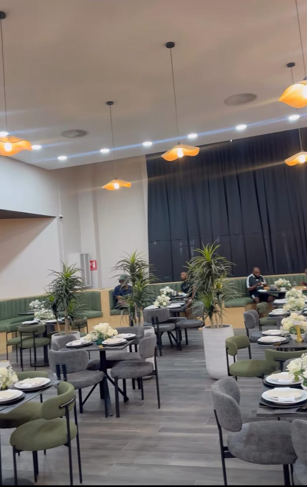 Finished restaurant with suspended ceiling, recessed downlights and pendant lighting