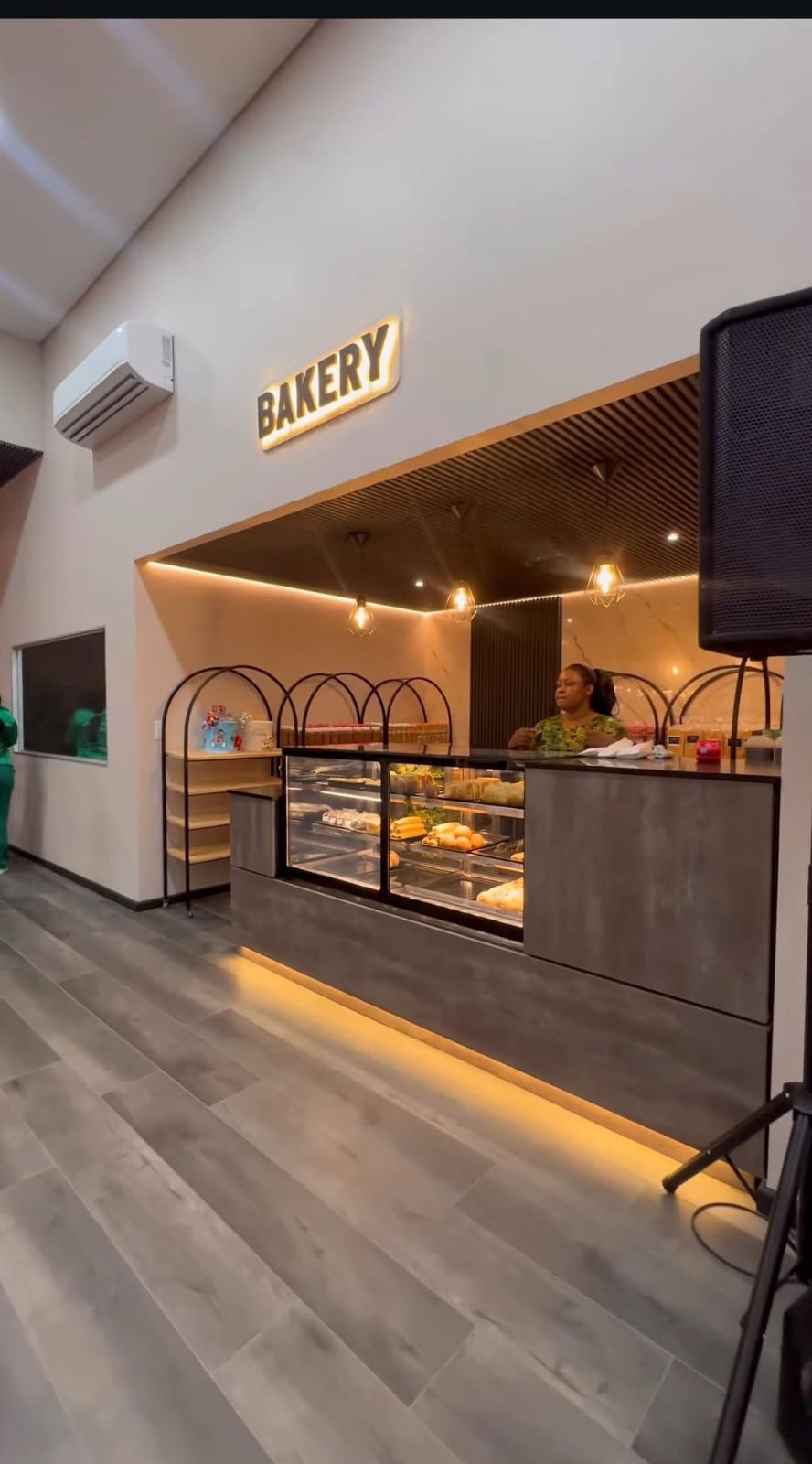 Bakery counter with a slatted timber ceiling feature and cove lighting