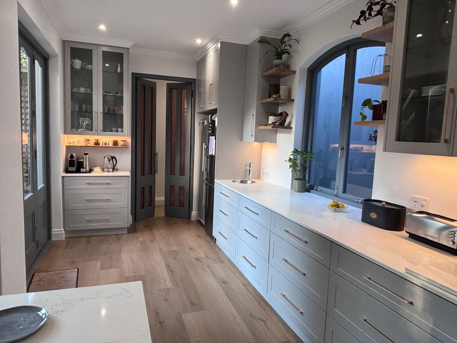 Freshly painted kitchen interior in soft grey with clean cornice lines