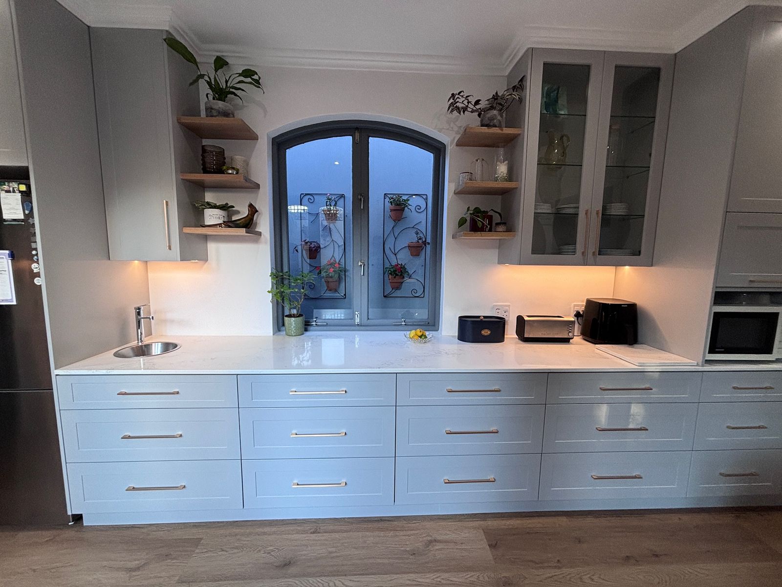 Kitchen cabinetry elevation with cornice and under-cabinet lighting